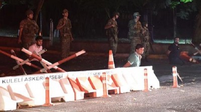 Turkish security officers detain unknown individuals on the side of the road on July 15, 2016 in Istanbul, during a security shutdown of the Bosphorus Bridge.