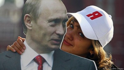 a-supporter-of-president-putton-is-posing-wiht-his-poster