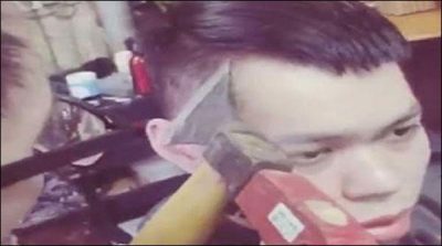 Morocco: the barber cutting hair with hammer and ax