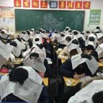 Chinese teachers wearing the student newspaper to stop the forgery in the examination room