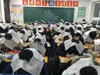 Chinese teachers wearing the student newspaper to stop the forgery in the examination room