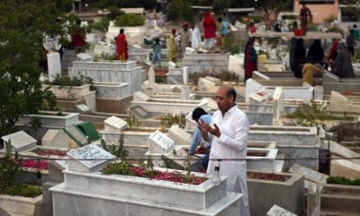 Pakistani Muslim families pray beside the graves of their relatives to mark Shab-e-Barat or the night of forgiveness in Karachi on June 2, 2015. Muslims believe that if someone prays to God throughout the night and seeks forgiveness for all the sins he may have committed, he could be forgiven. The entire night of prayer is devoted to asking for forgiveness for the past year and for good fortune in the year to come. AFP PHOTO/Asif HASSAN