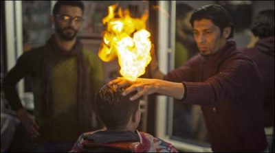 Expert hairdressers hair cutting with fire unique techniques