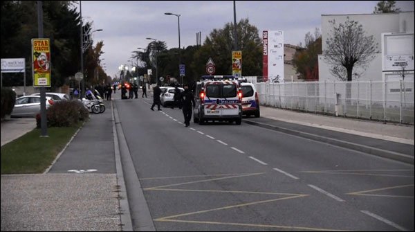 FRANCE: A person carries car on 3 Chinese students