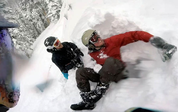 Snowboarder being rescued from snow