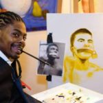 Disabled American youth painting through the mouth