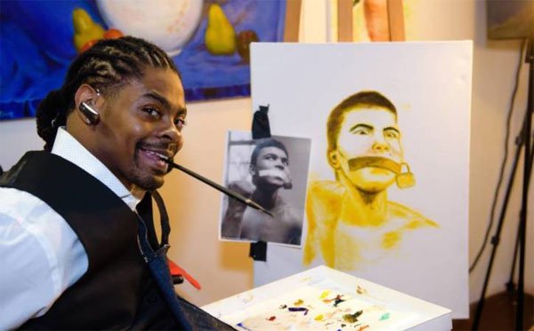 Disabled American youth painting through the mouth