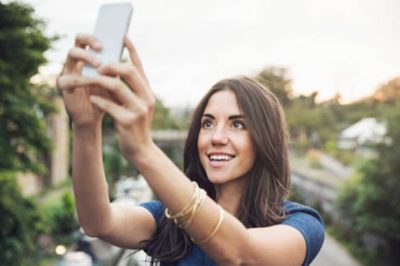 Why does the nose appear spread out in the selfie?