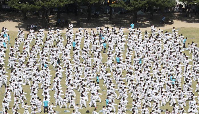 Thousands of people demonstrate performing martial arts