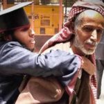 Upon graduation of the disabled son, satisfaction and happiness on the old Yemeni face