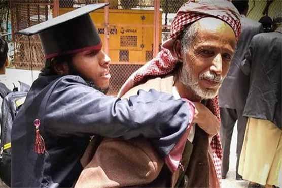 Upon graduation of the disabled son, satisfaction and happiness on the old Yemeni face
