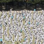 Thousands of people demonstrate performing martial arts