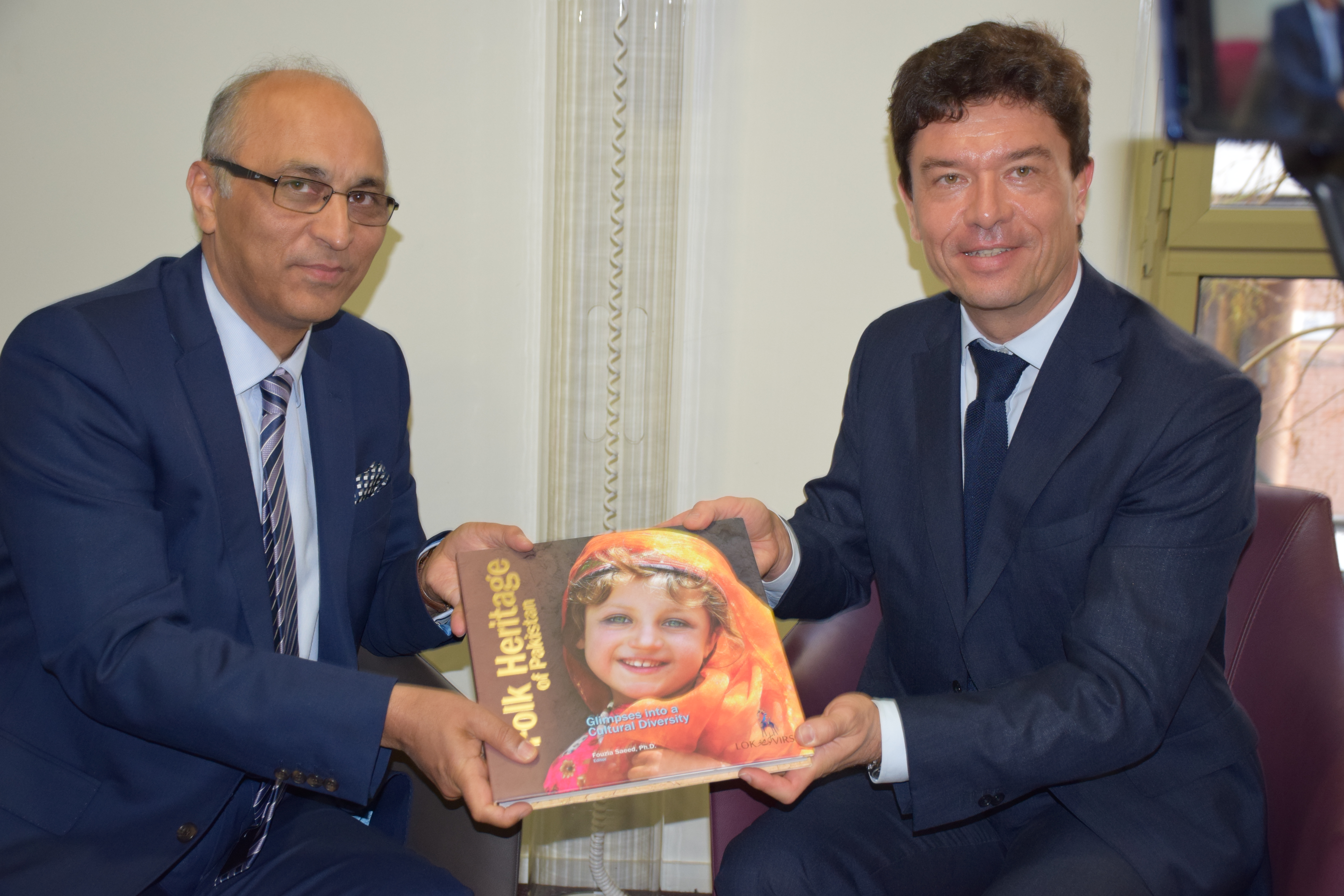 Ambassador of Pakistan to France Mr. Moin ul Haque is presenting a book titled Folk Heritage of Pakistan to VP INALCO